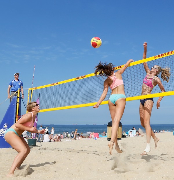 People playing beach volleybal at the beach. 