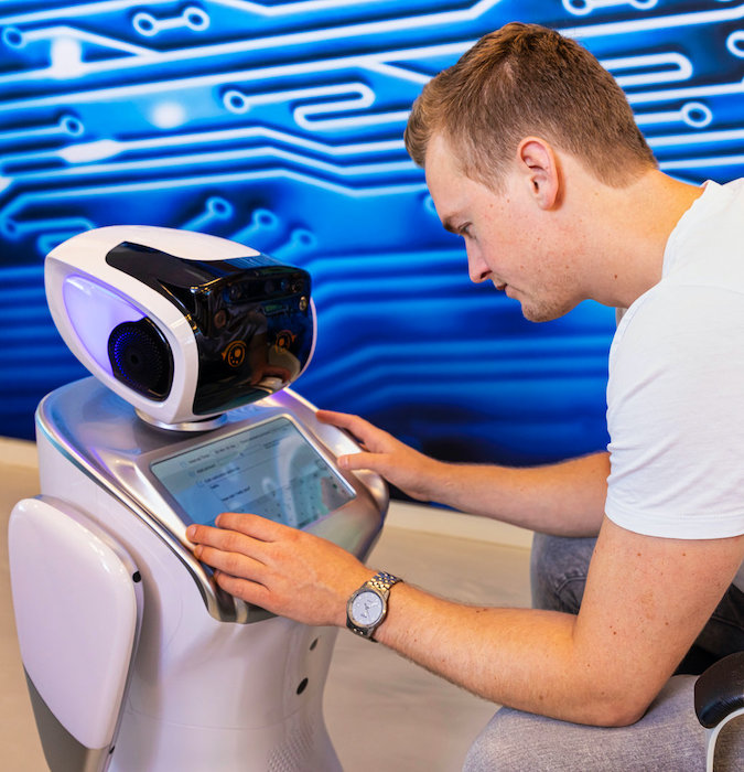 Man working with a robot. 