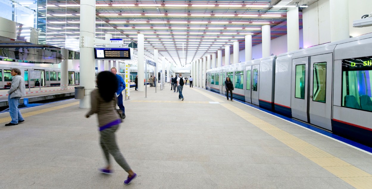 Person walking at a metro station in Rotterdam. 