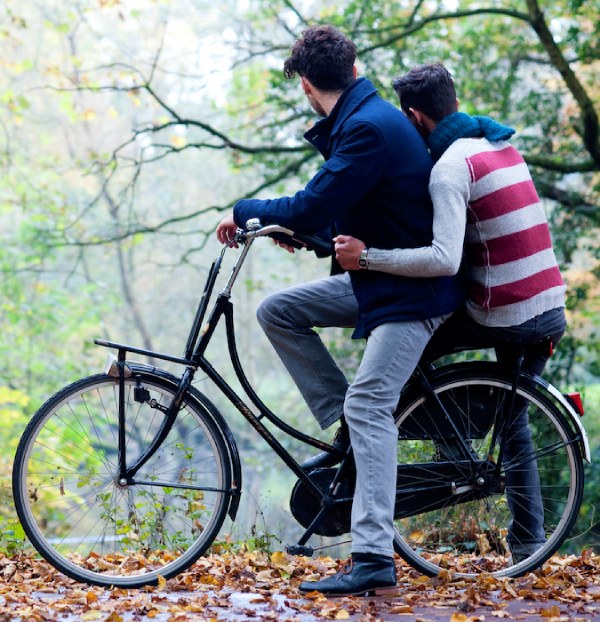 Two persons driving bike in the forrest. 