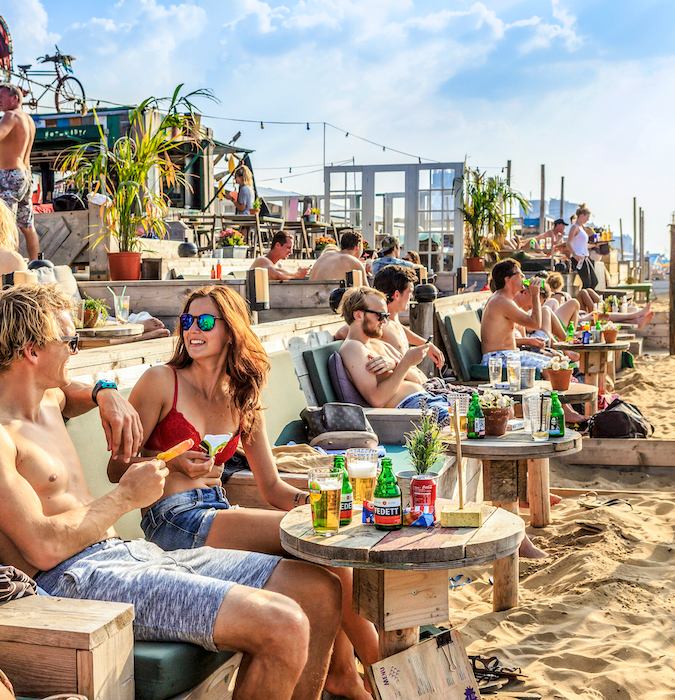 People having a drink on a terrace at Scheveningen beach. 