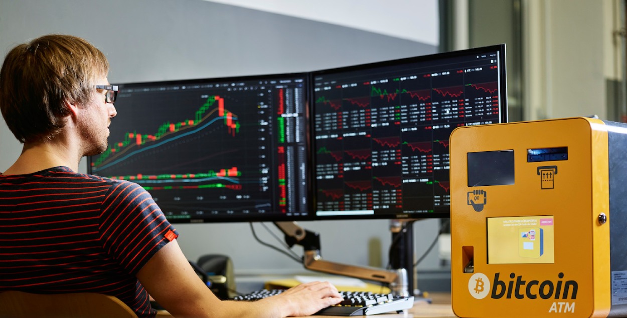 Employee working on the computer on bitcoin blockchain