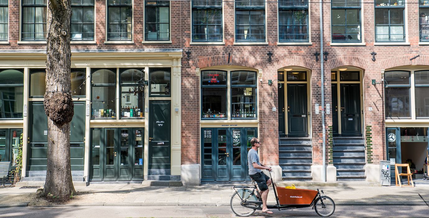 A man cycling in Amsterdam. 