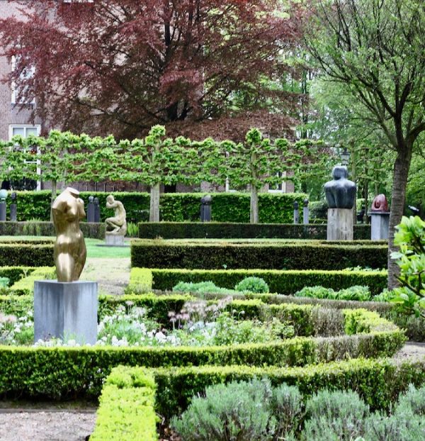 A Garden with statues and vegetation.