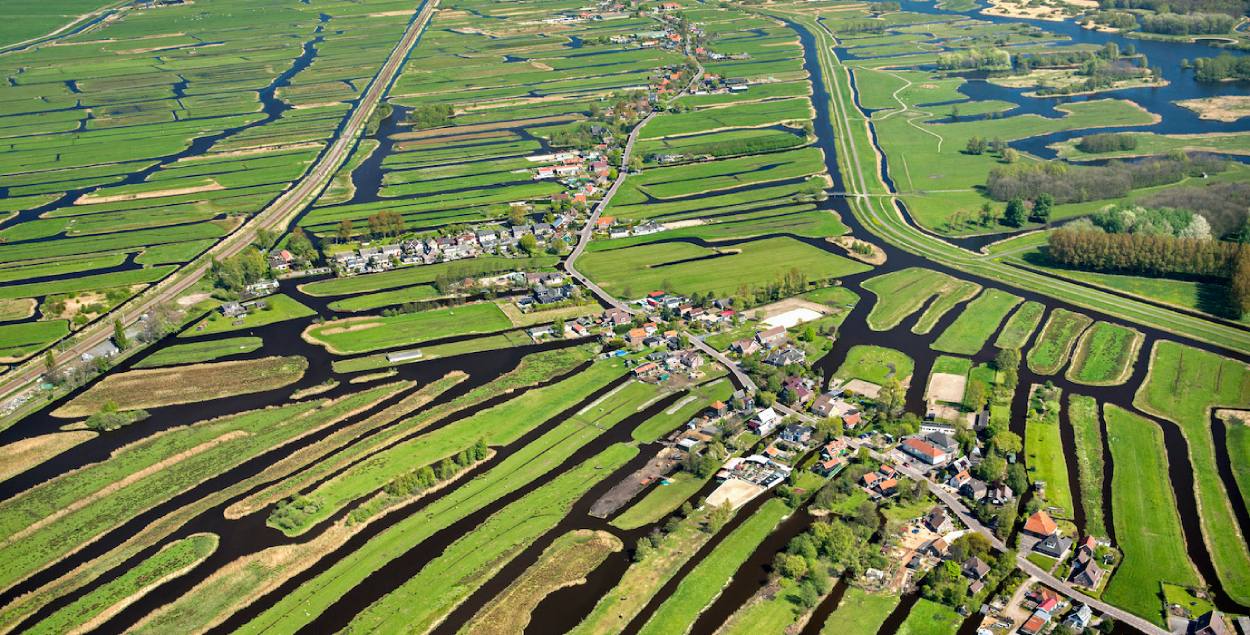 Sky picture of Dutch landscape with water and green fields