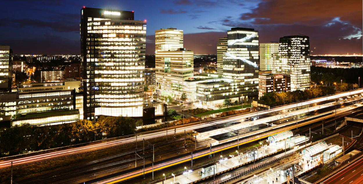 Business center of Amsterdam and train station by night. 