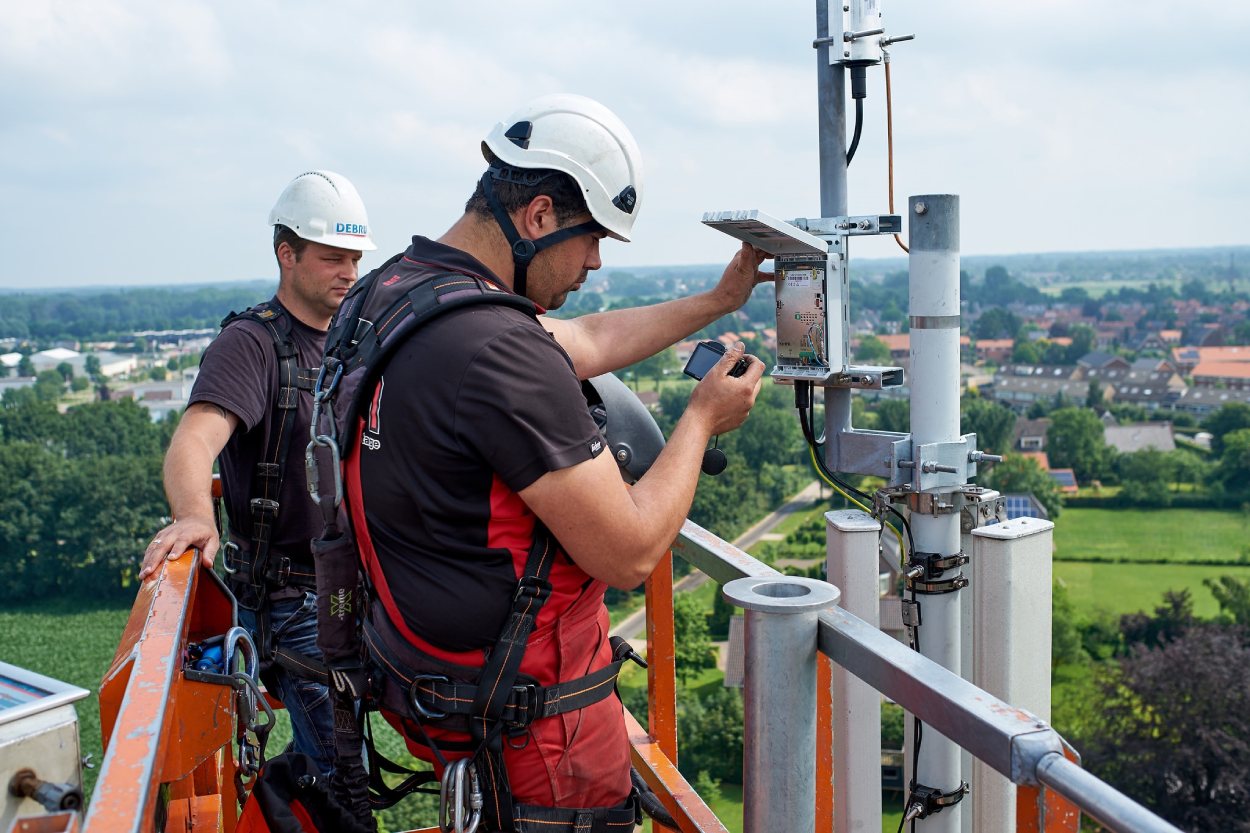 Two employees working at a base transceiver station