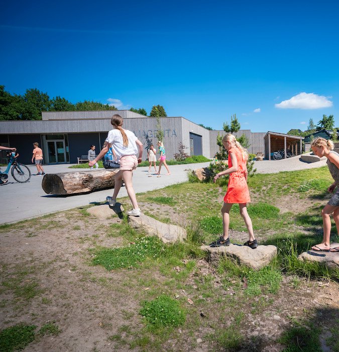 Children playing outside in the schoolyard.
