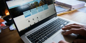 Person filling in tax forms on a laptop. 