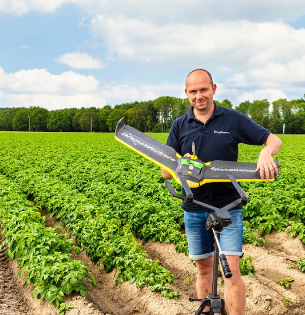 Man using a drone on a field. 