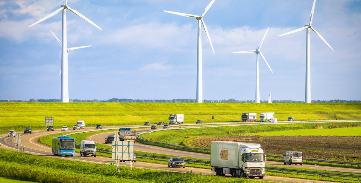 A highway with windmills in the background. 